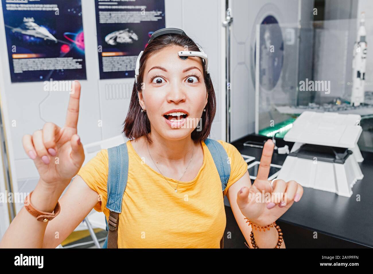 Funny Woman with digital headwear equipment sensor connected to her ear,  reading brain impulses. Future technology concept Stock Photo - Alamy