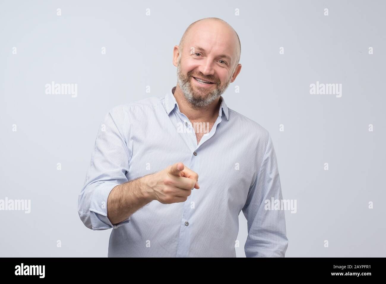 Mature laughing handsome excited, happy man pointing at you camera gesture with finger, isolated on white background. Positive emotion facial expressi Stock Photo