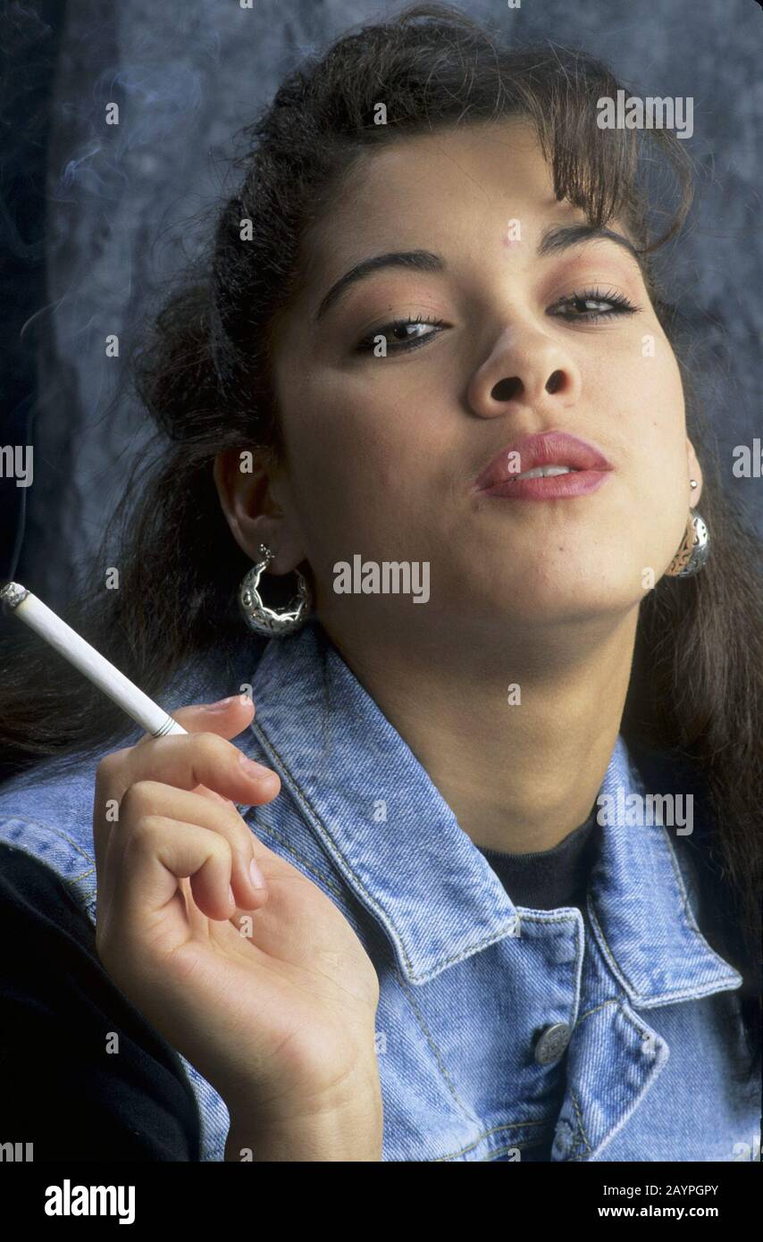 Studio portrait of 17yearold girl smoking a cigarette. ©Bob Daemmrich