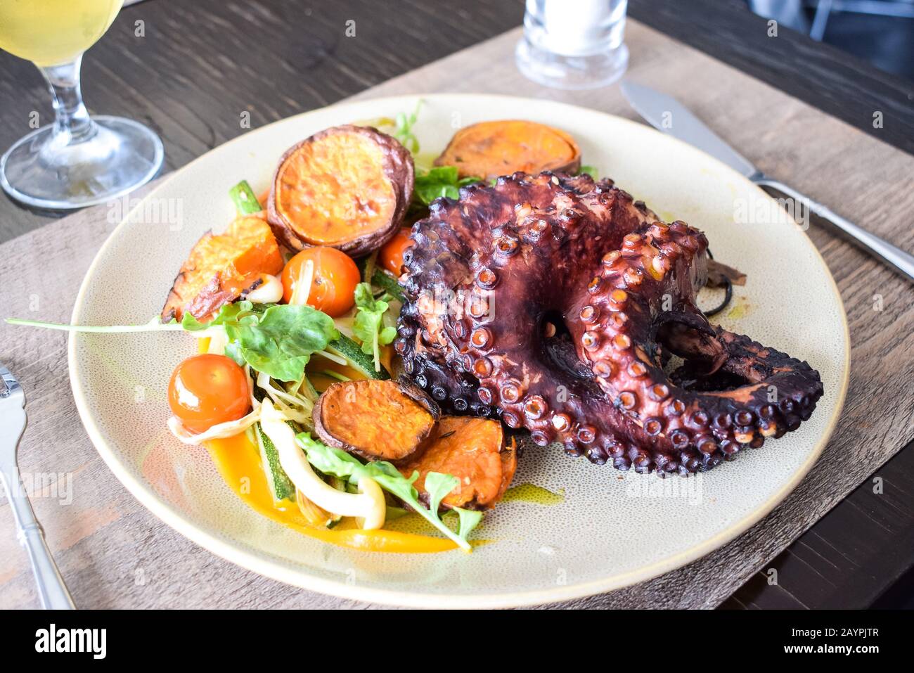 Octopus with vegetables, seafood dish Stock Photo Alamy
