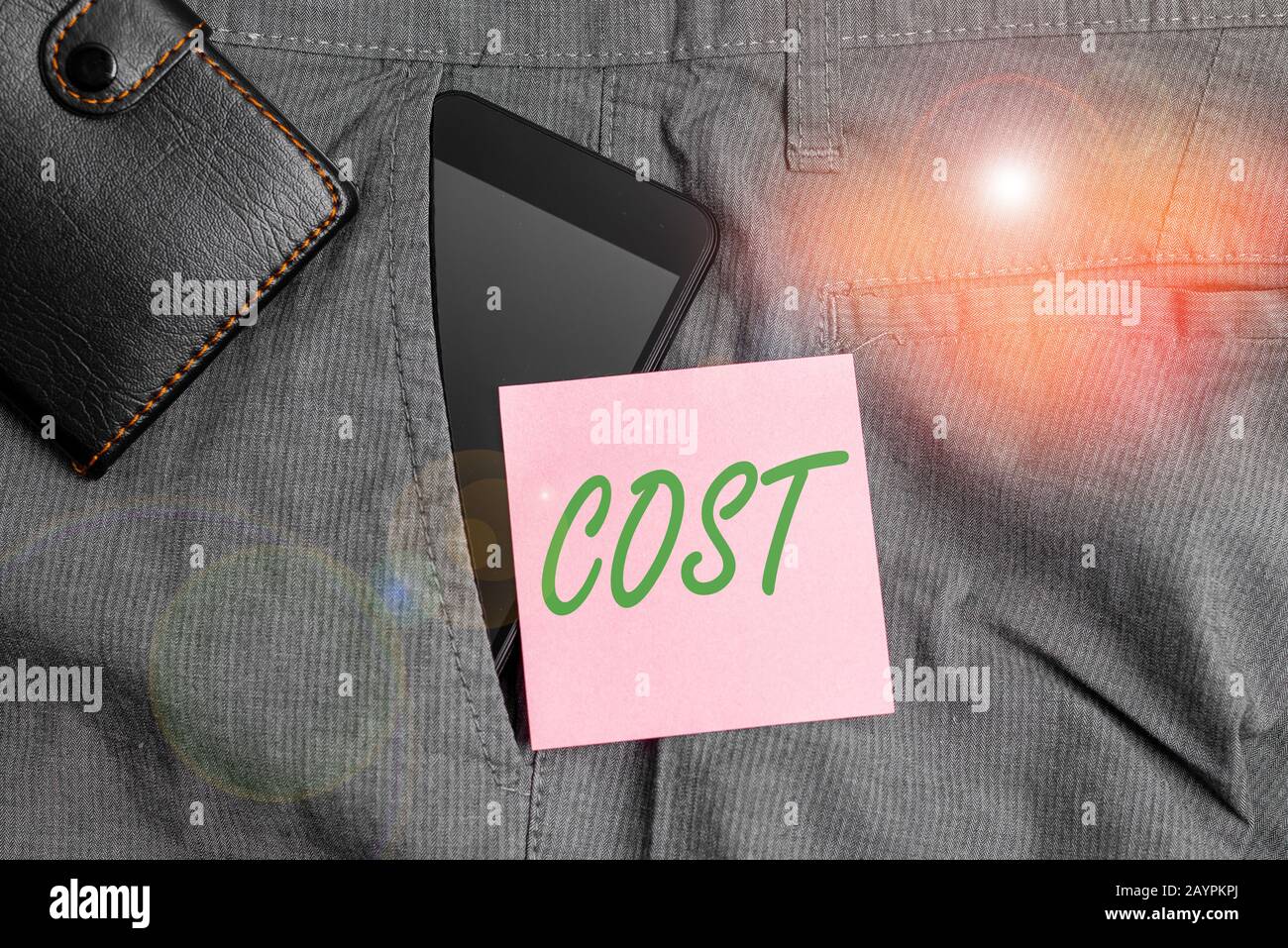 Handwriting text Cost. Conceptual photo The amount that usualy paid for a item you buy or hiring a demonstrating Smartphone device inside trousers fro Stock Photo