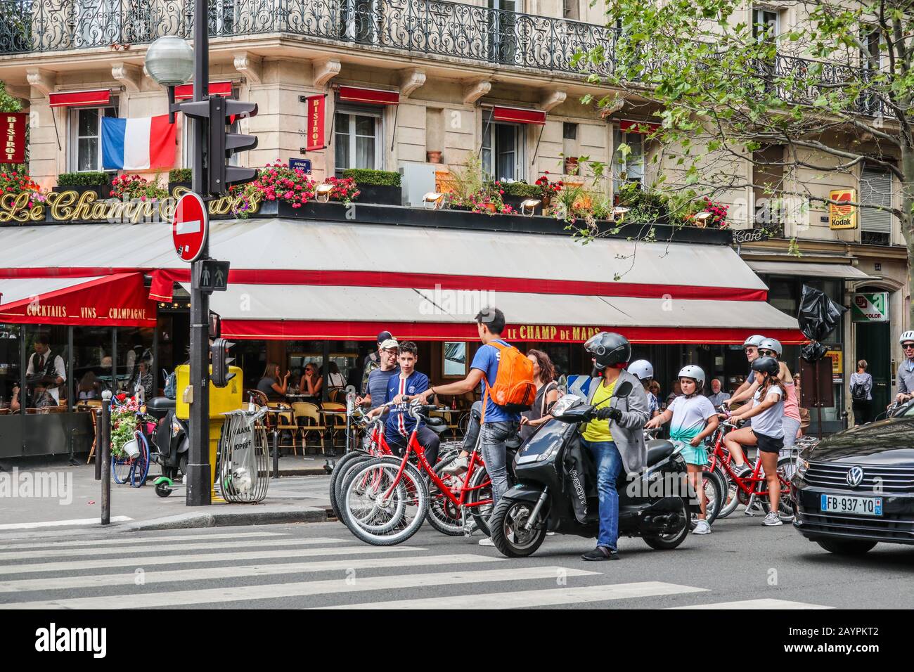 Moped rider and cyclists waiting at zebra crossing in Paris, France, Europe Stock Photo