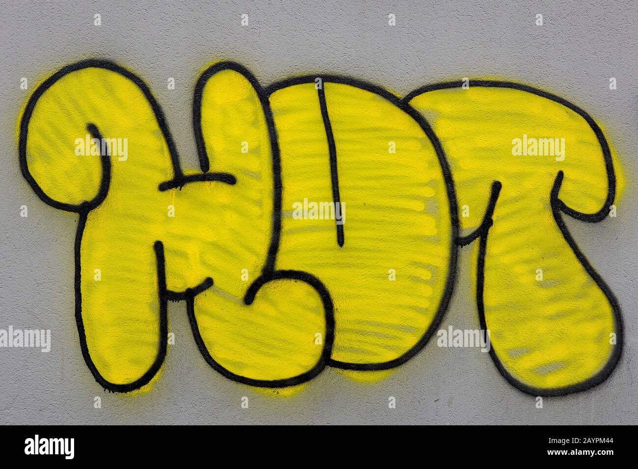 Modern graffiti in a street of the suburbs of Milan, Italy, depicting the yellow tag Hut Stock Photo