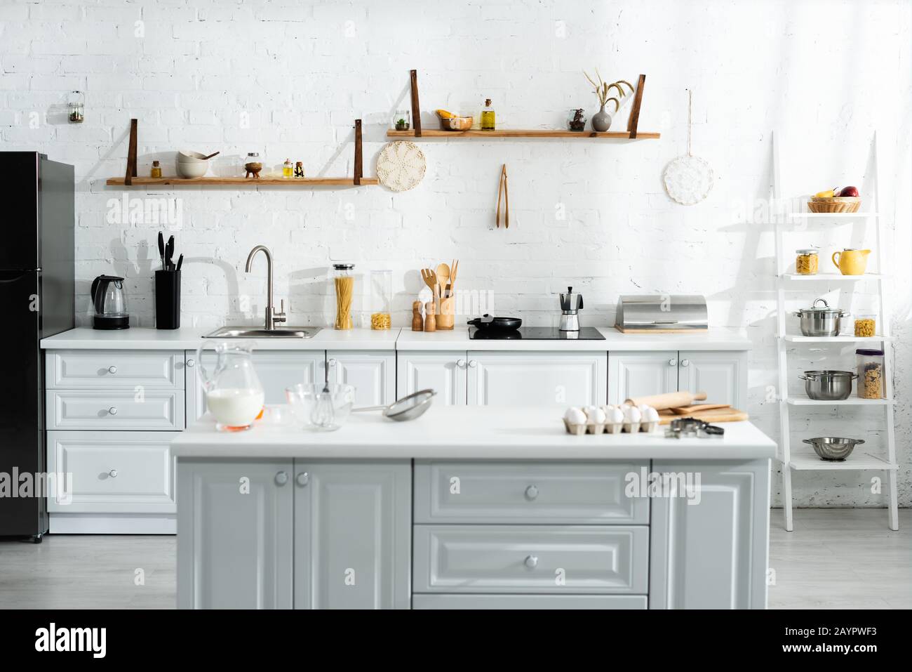 interior of kitchen with cooking utensils, food, milk and