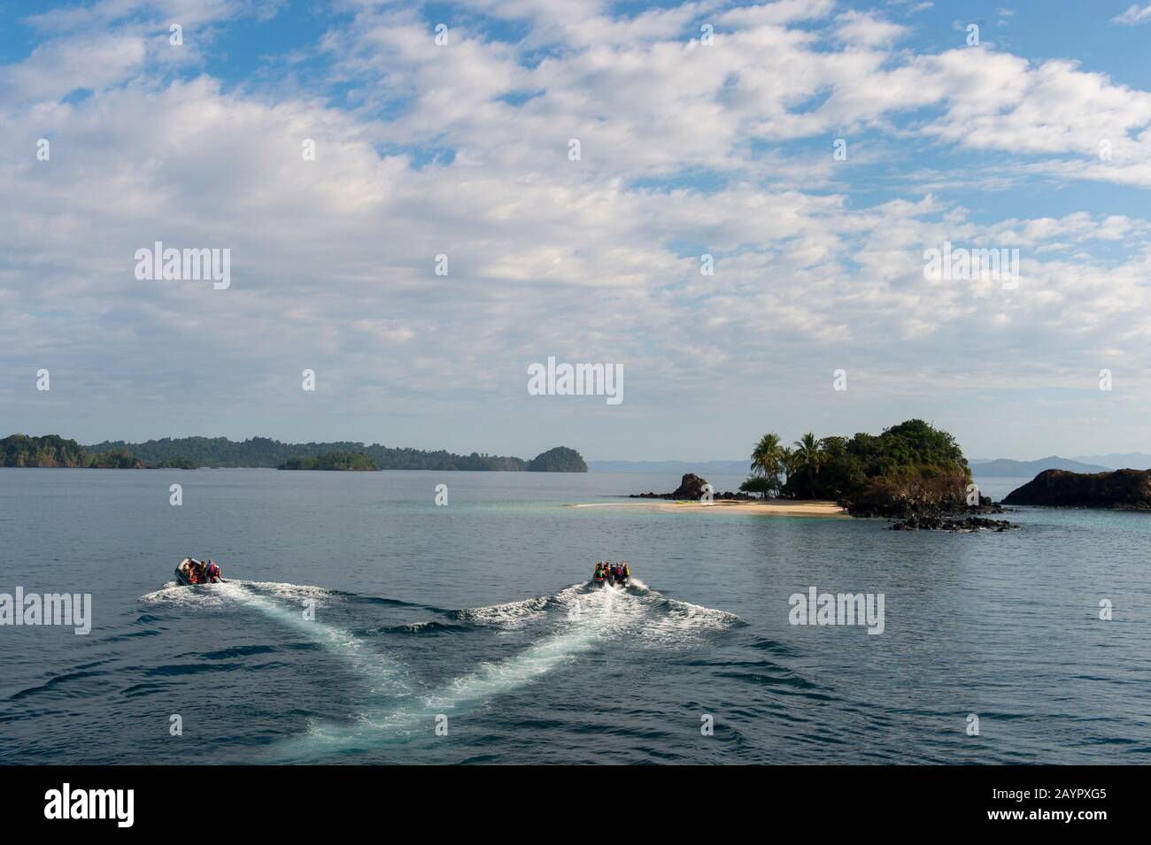 Zodiacs approaching the small island of Granito de Oro in Coiba National Park in Panama. Stock Photo