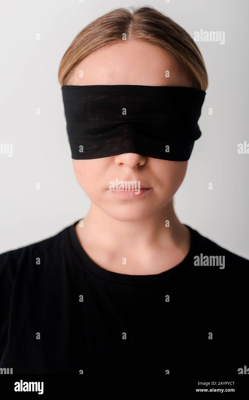 Young Woman Wearing Black Blindfold Isolated On Grey Stock Photo