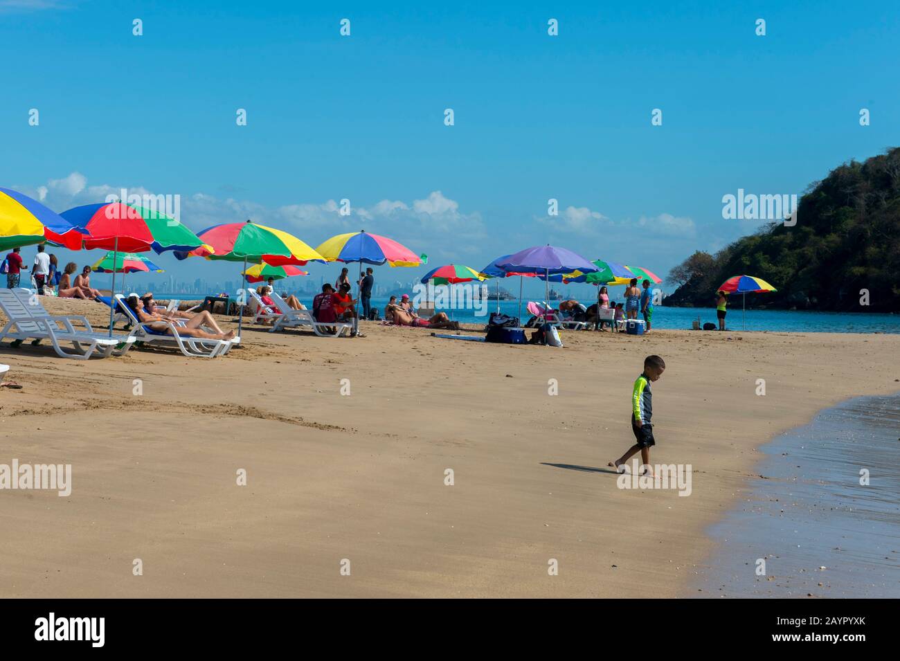 Beach scene with colorful umbrellas on the tropical island of Isla Taboga off the coast of Panama City, Panama. Stock Photo