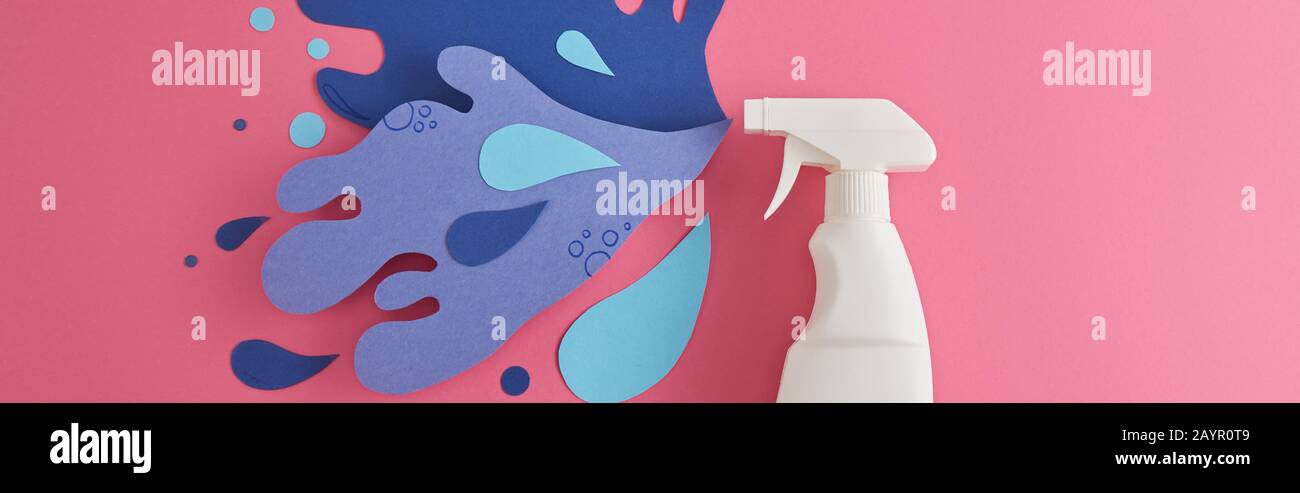 panoramic shot of composition with detergent bottle and blue water splash made of paper, on pink Stock Photo