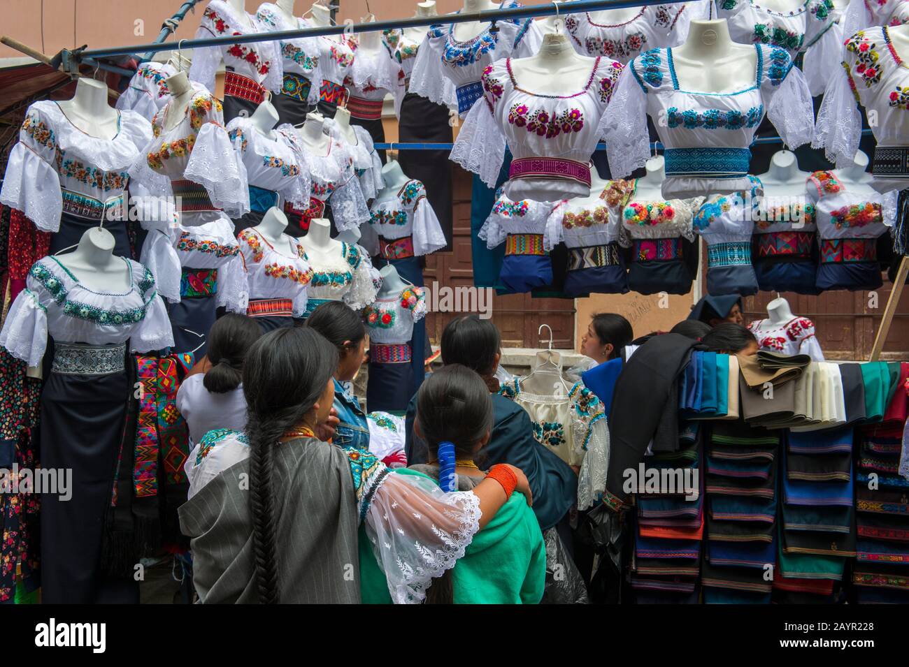 Local women shopping for blouses on the local market in the town of Otavalo in the highlands of Ecuador near Quito. Stock Photo