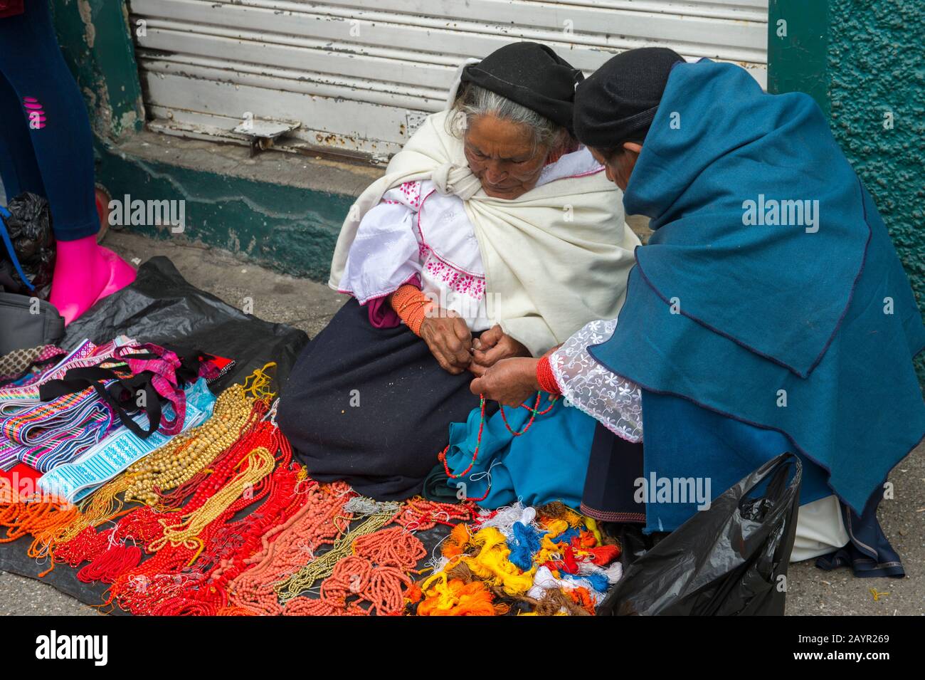 A local woman is selling necklaces on the local market in the town of Otavalo in the highlands of Ecuador near Quito. Stock Photo