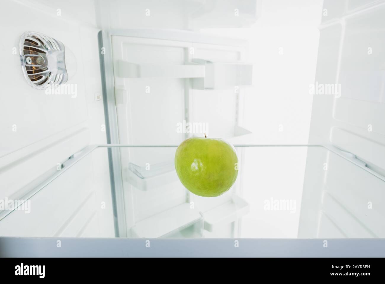 Juicy green apple in refrigerator with open door isolated on white,stock image Stock Photo Alamy