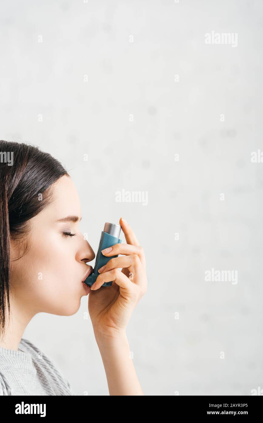 Person Using Inhaler Shadow Side view of woman using inhaler on white background Stock Photo - Alamy