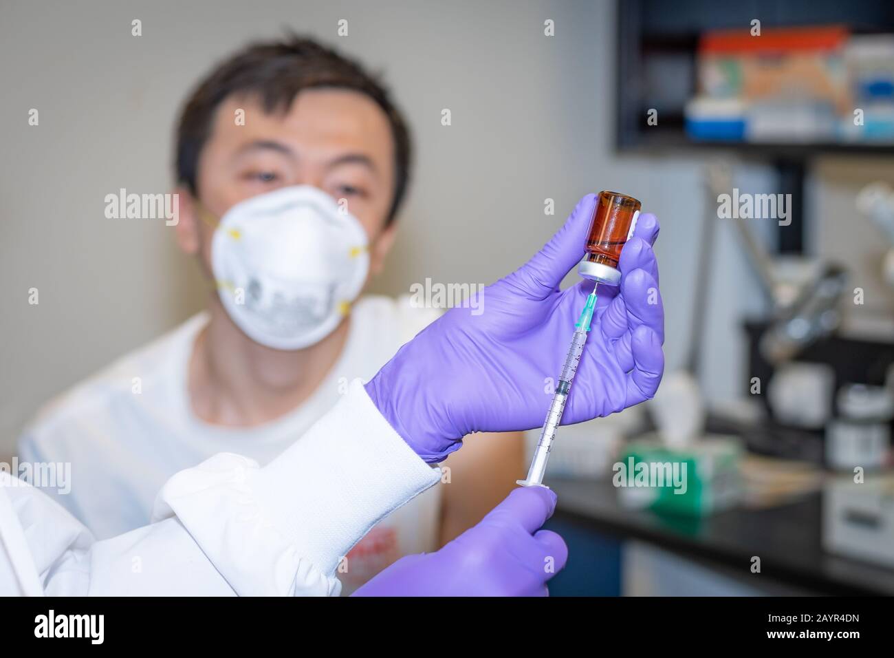 Chinese male receiving flu vaccine in clinic Stock Photo