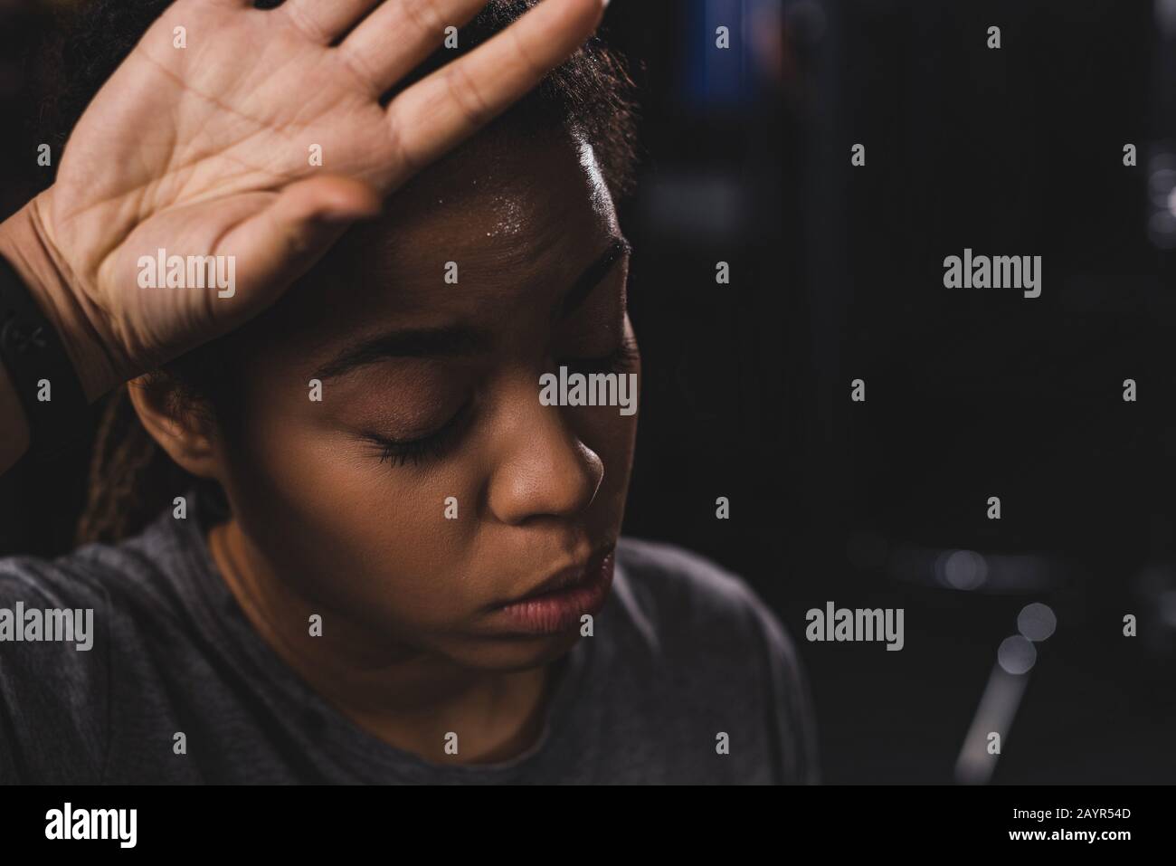 african american girl with closed eyes wiping sweat with hand Stock Photo -  Alamy