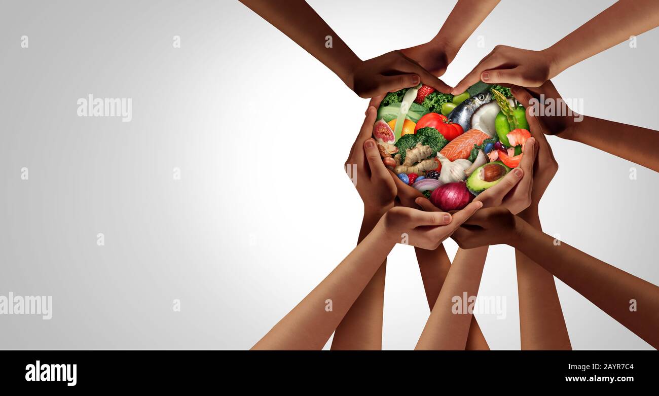 People eating healthy as a group of hands shaped as a heart as a dining concept and nutrition symbol for as a health lifestyle. Stock Photo