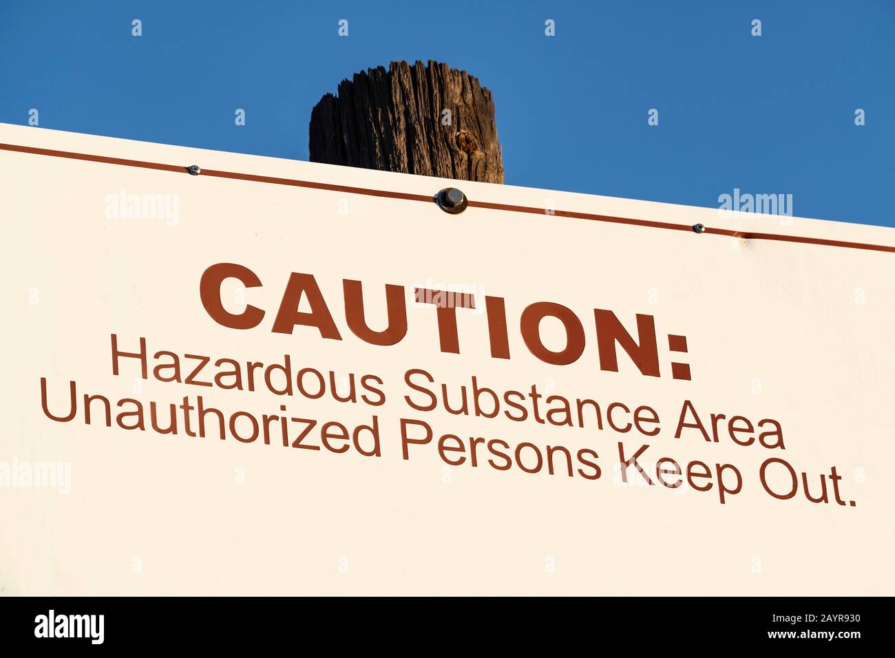 Old caution hazardous substance area unauthorized persons keep out sign. Stock Photo