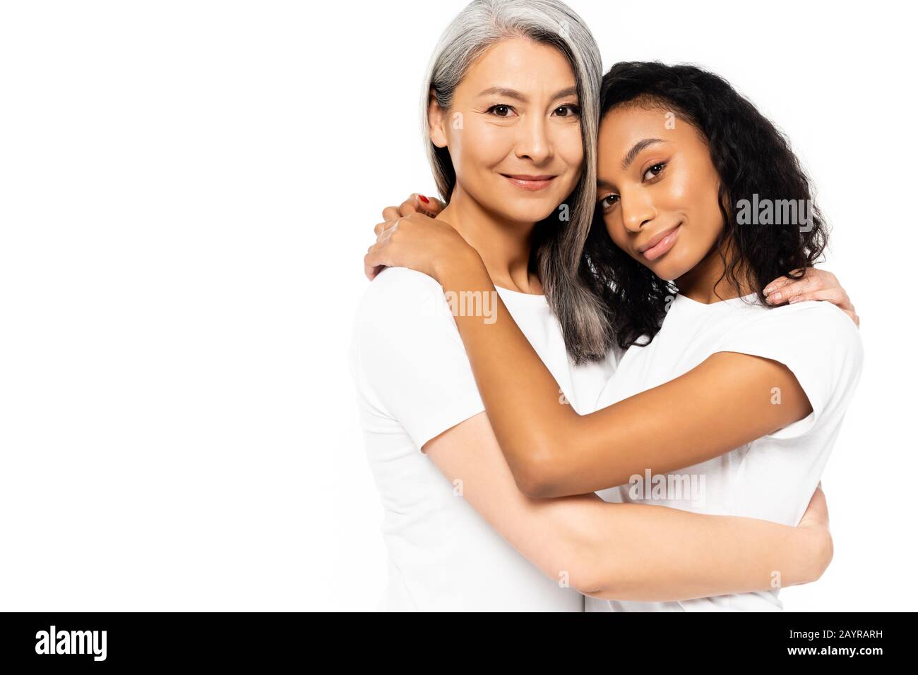 happy african american and asian women hugging isolated on white Stock Photo