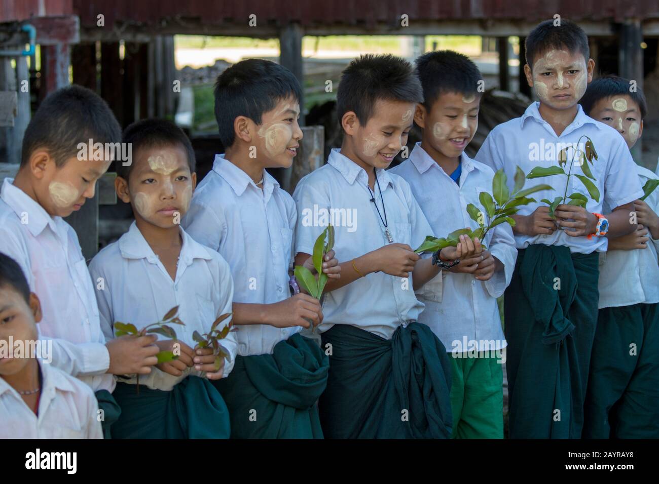 School children in school uniform lined up to great tourists at the village  of Kuwoo on Inle Lake in Myanmar Stock Photo - Alamy