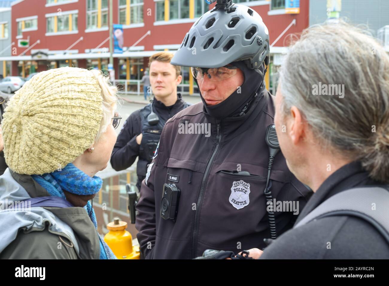 Seattle Police speak with the leader of a group of protesters blocking a freight and passenger rail line through Seattle Stock Photo