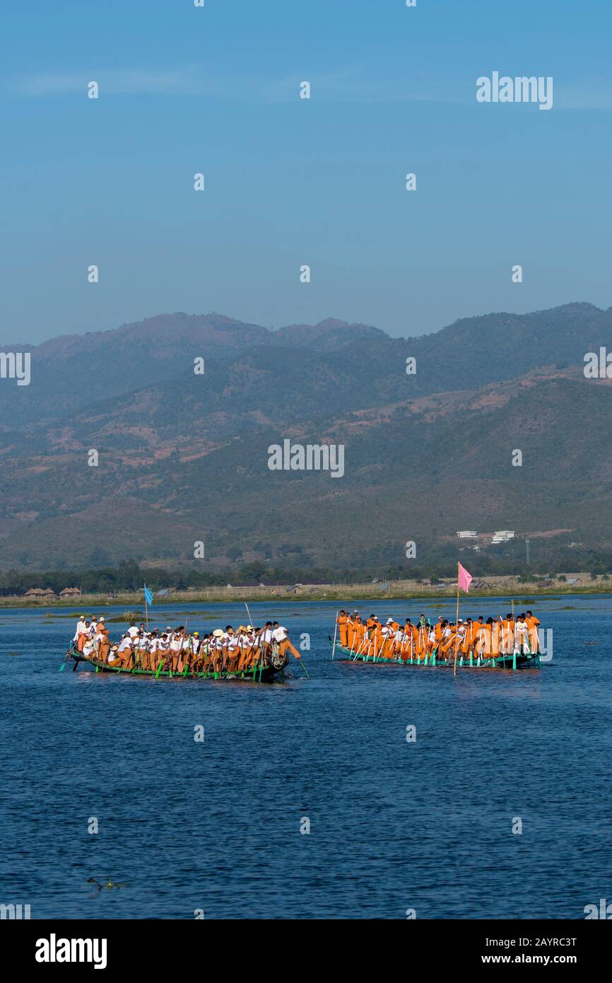 A traditional leg-rowing boat race accompanied with music on Inle Lake ...