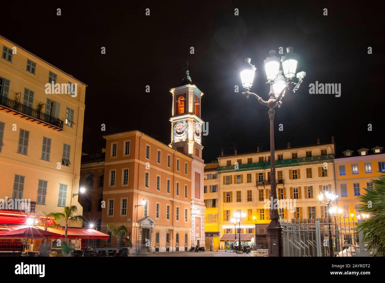 Late night view of Rusca Palace, bell clock tower and cafes in the Old Town Vieux Nice of Nice, France, on the French Riviera. Stock Photo