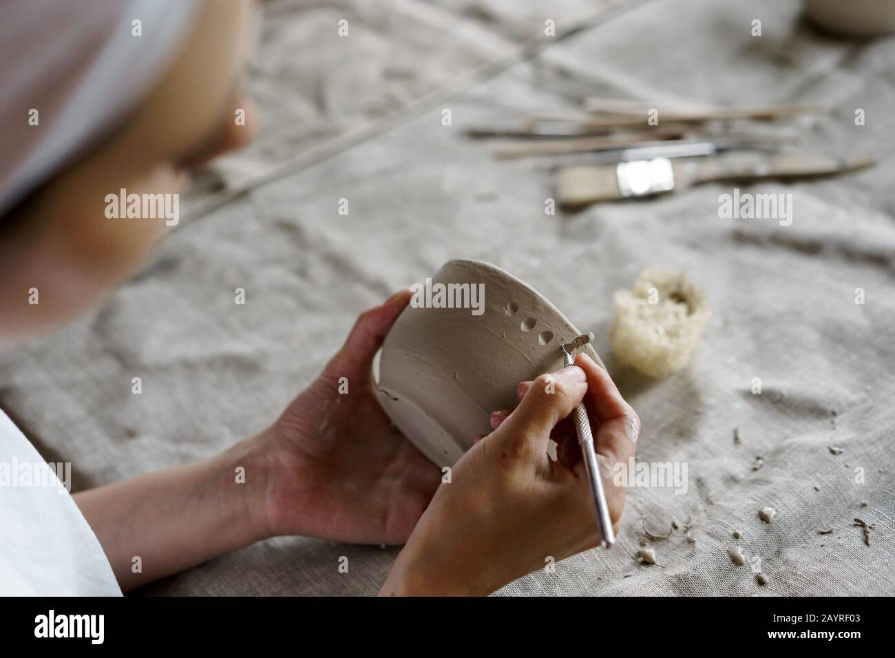 Female hands hold a bowl for casting clay products Stock Photo