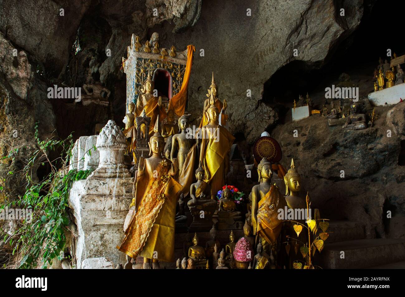 Thousands of Buddha statues are in the Tham Ting (lower cave) of the Pak Ou Caves, situated in a limestone mountain above the Mekong River near Luang Stock Photo
