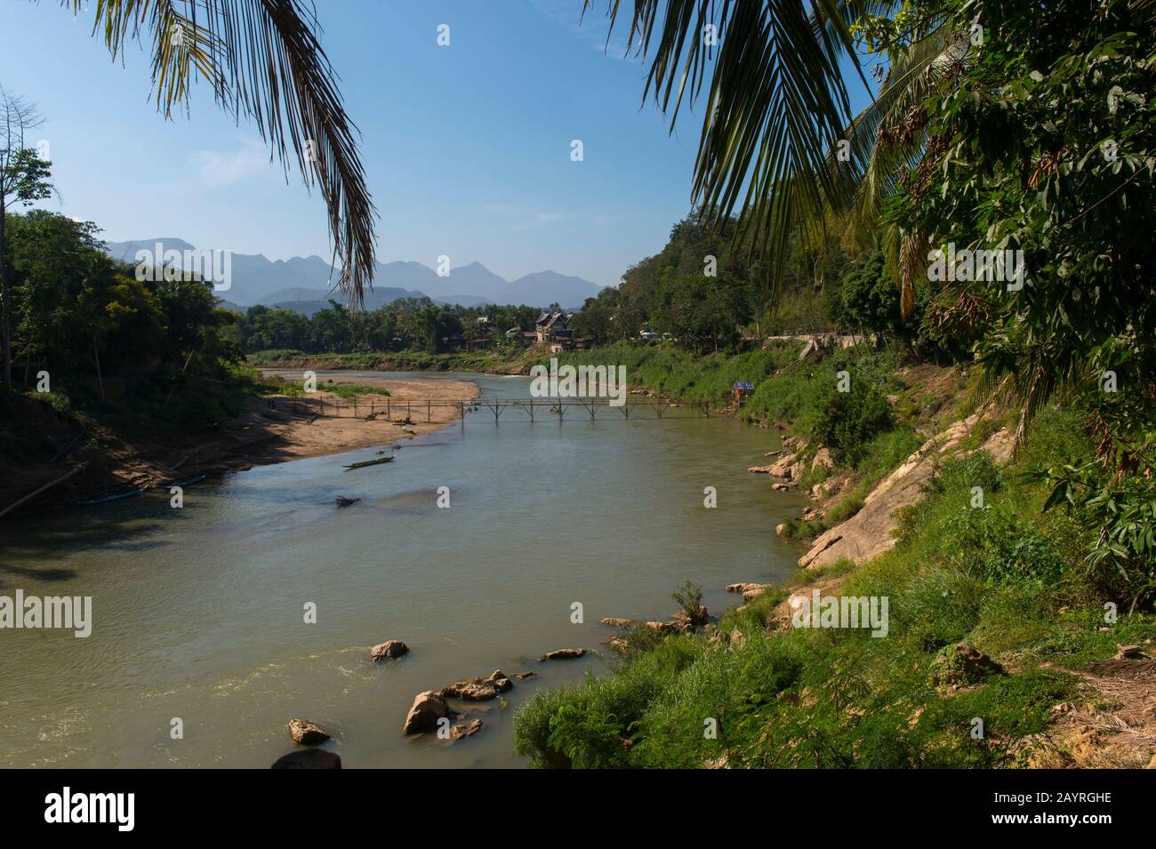 View of a bamboo bridge over the Nam Khan River in Luang Prabang in Central Laos. Stock Photo