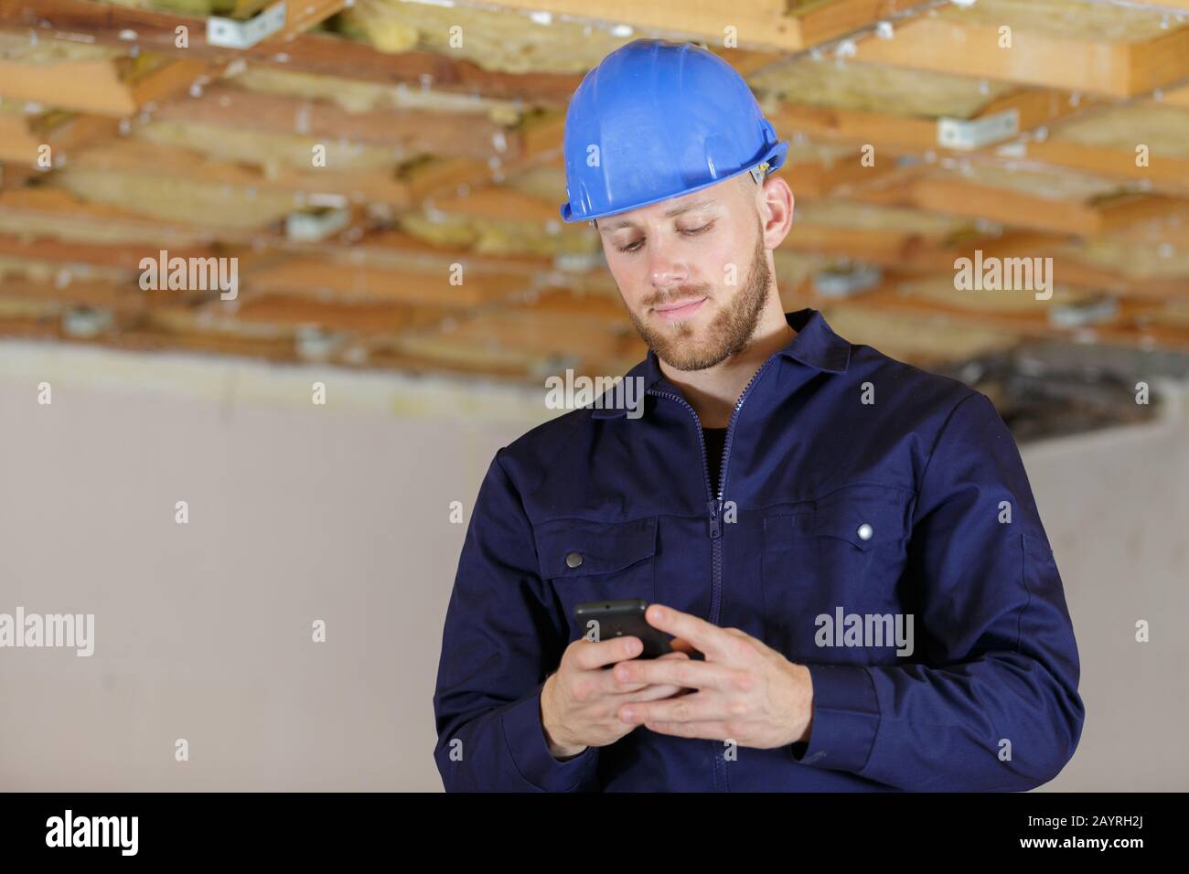 Construction texting on mobile phone hi-res stock photography and ...