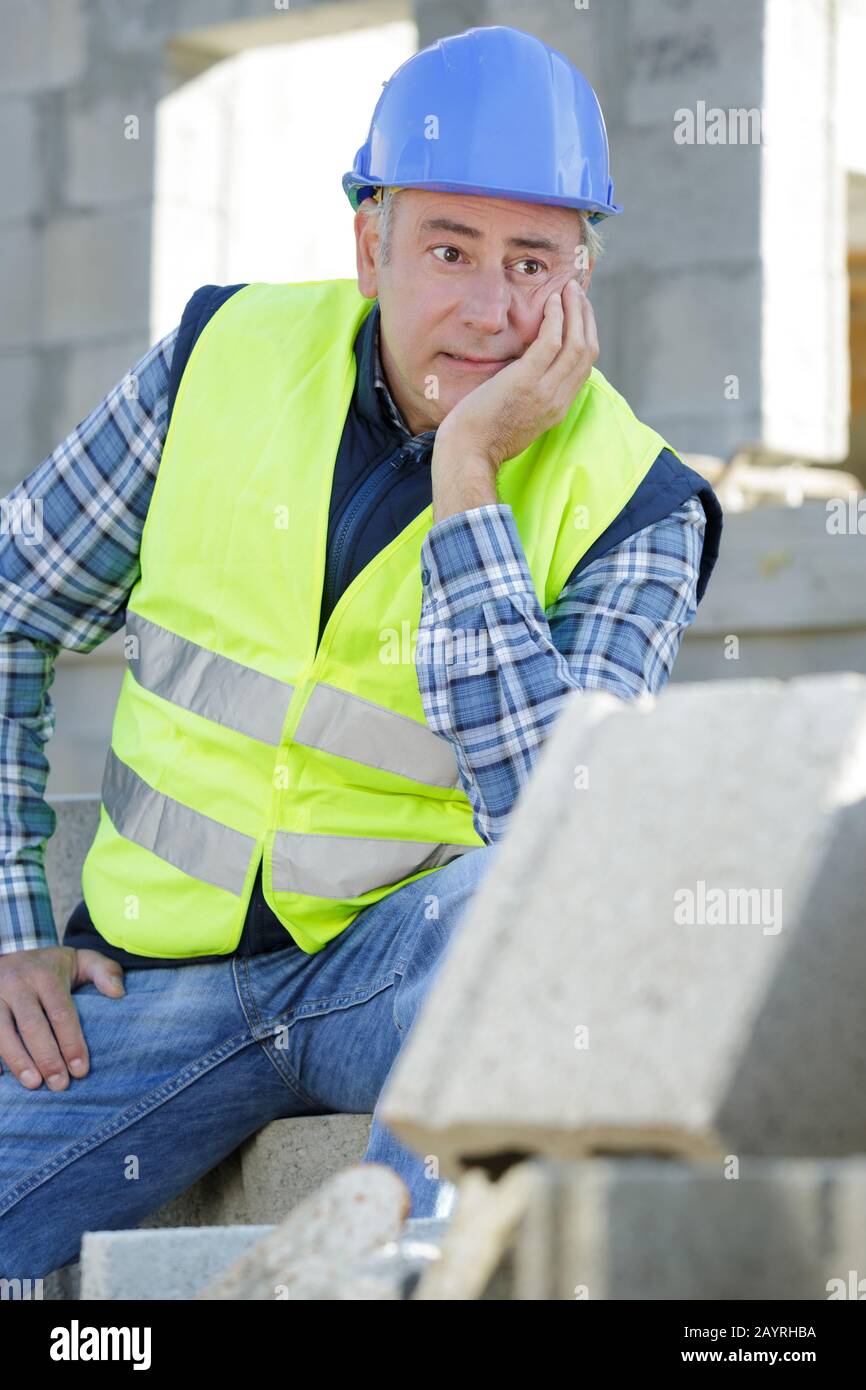 male builder next to cement block wall construction Stock Photo - Alamy