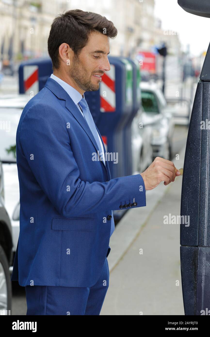 man paying for his parking ticket on the machine Stock Photo