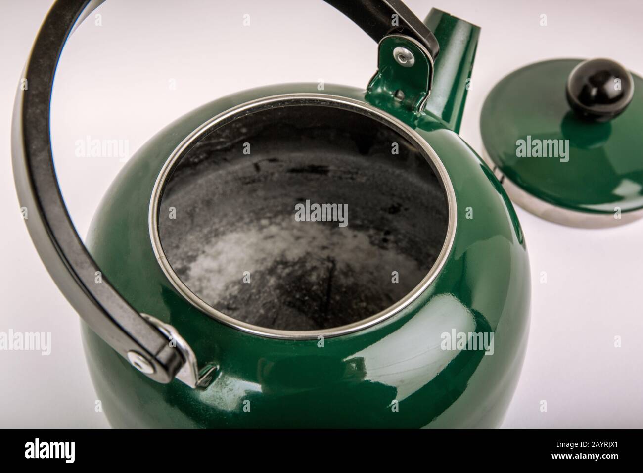 One of the signs of a well-used tea kettle can be a layer of hard water buildup. Stock Photo