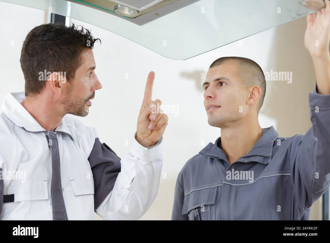 Point At Building builder point at furniture indoors Stock Photo - Alamy