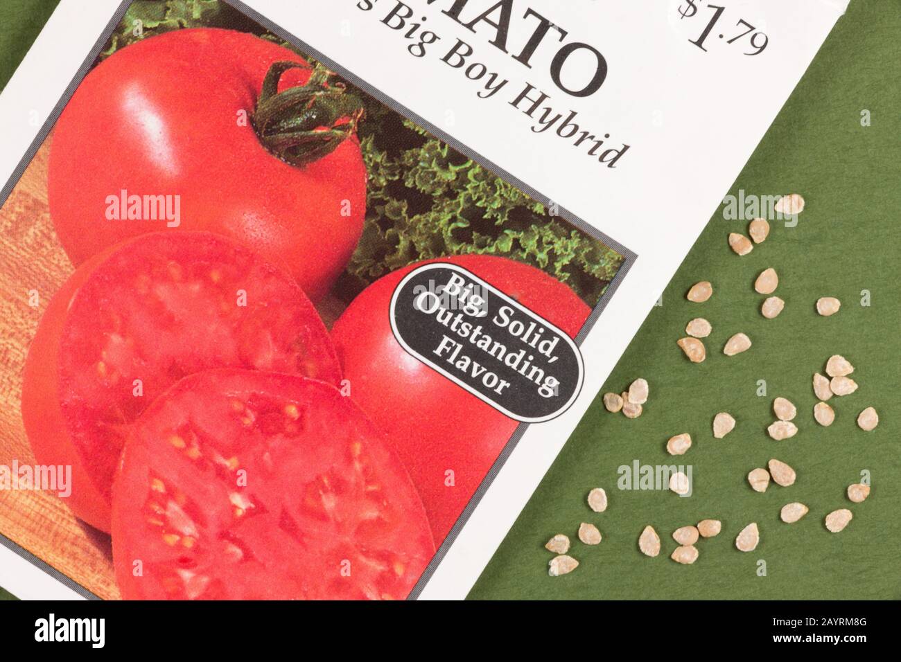 Close-up of Big Boy Hybrid tomato seeds and tomato seed packet in a studio setting Stock Photo