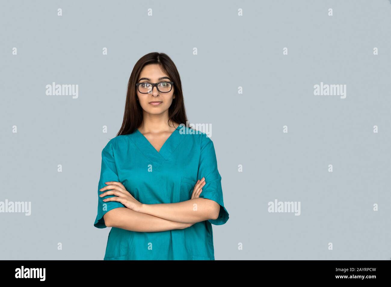 Young adult indian woman nurse in doctor uniform crossed hand on chest Stock Photo