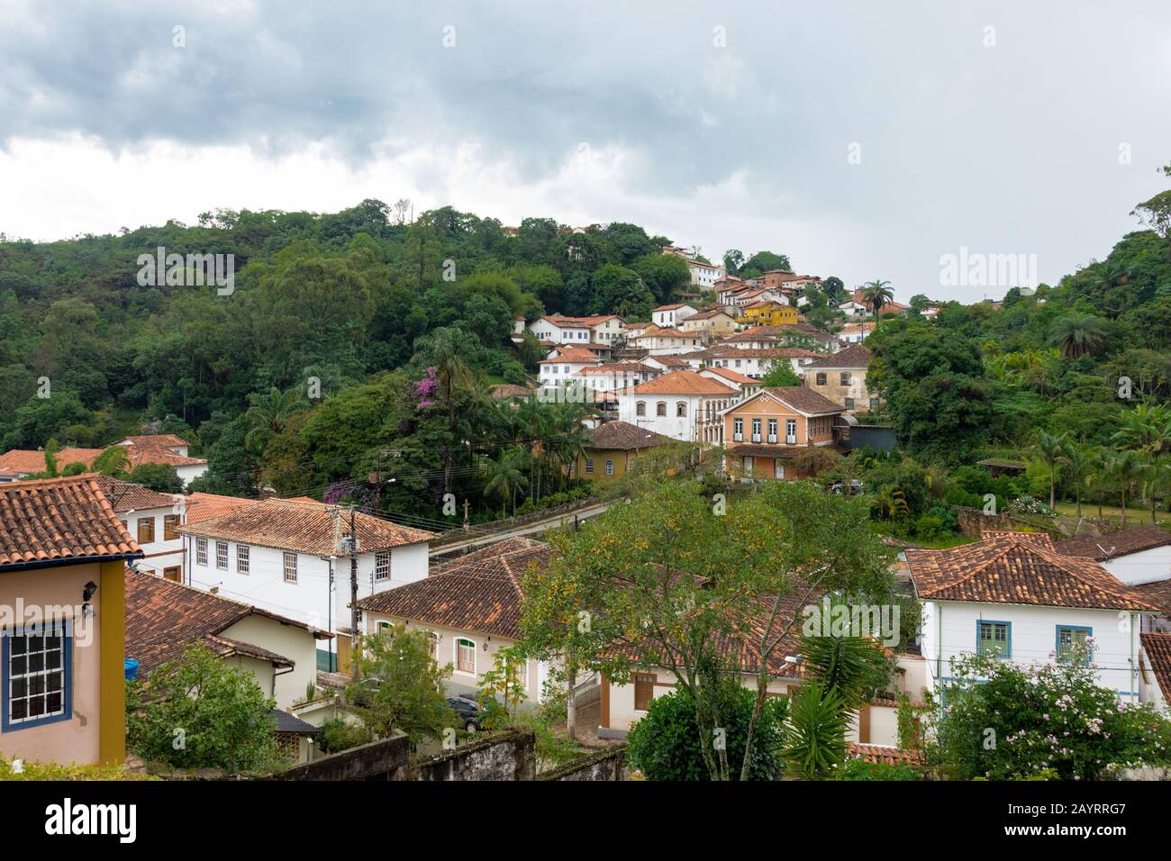 OURO PRETO, MINAS GERAIS, BRAZIL - DECEMBER 22, 2019: Colonial style houses in the mountain with 'Agua Limpia' neightborhood in the background. Ouro P Stock Photo