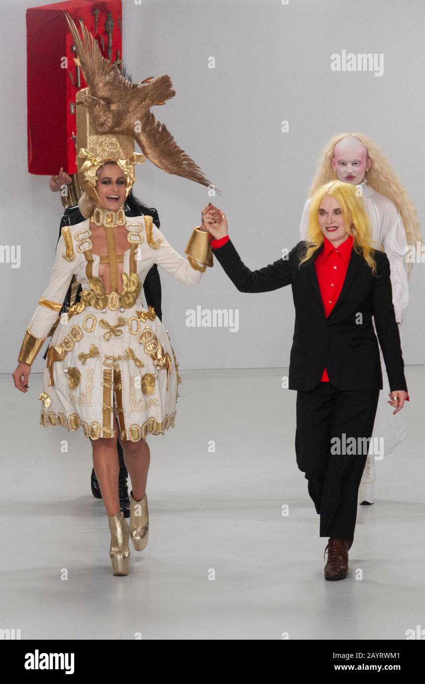 Pam Hogg walks with three of her models at the close of her AW20 Catwalk Show during London Fashion Week at Fashion Scout, Victoria House, London, UK. Credit: Antony Nettle/Alamy Live News Stock Photo