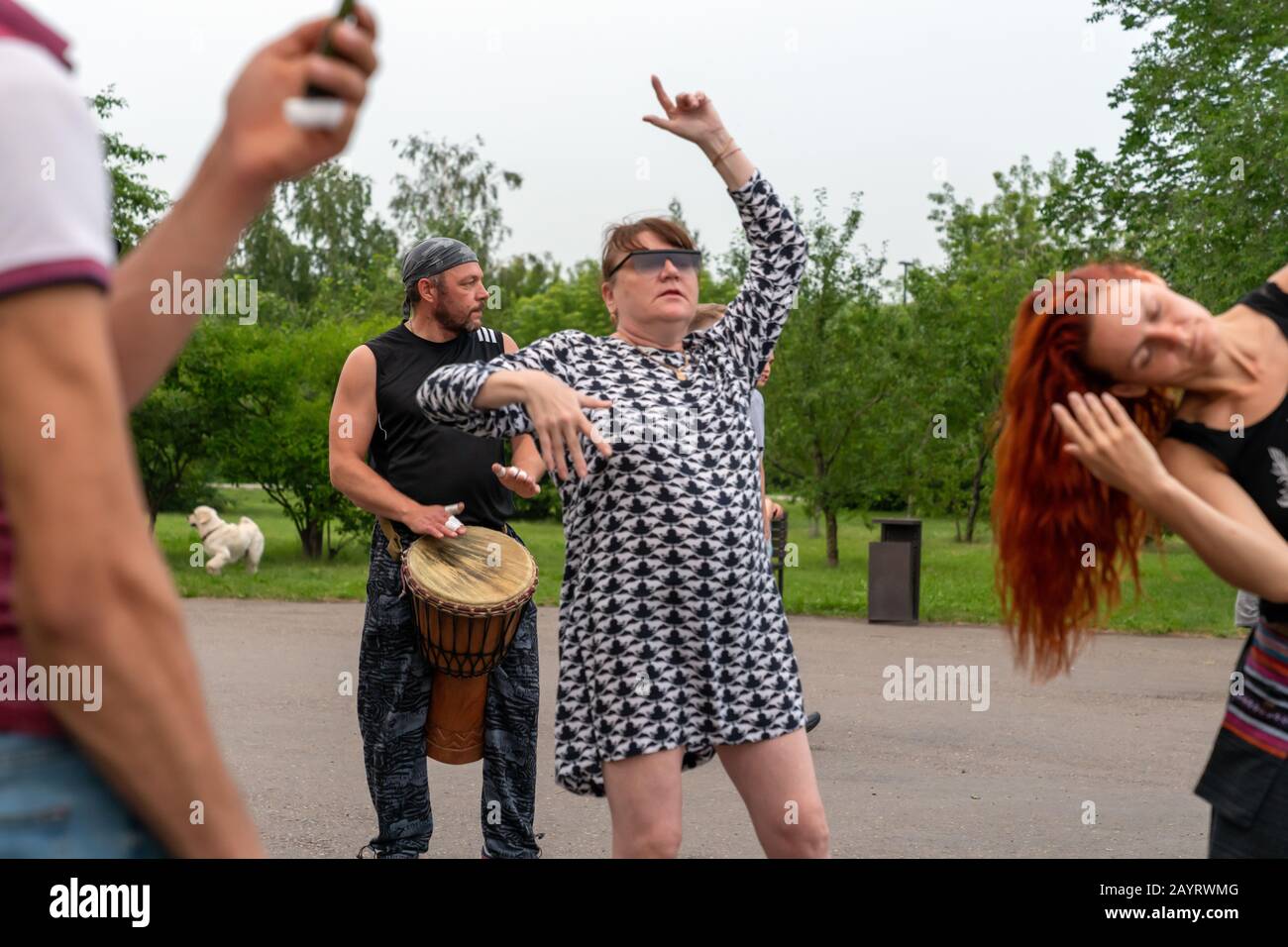 Krasnoyarsk, Russia, June 30, 2019: an adult female freak dances to African Tam Tam drums in a public Park. party. Stock Photo