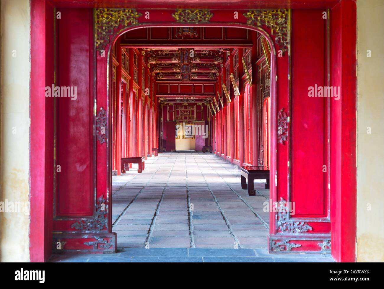 Symmetrical Corridor and Red Doors in the Forbidden Purple City, Historic Imperial Palace and United Nations World Heritage Site in Hue, Vietnam Stock Photo
