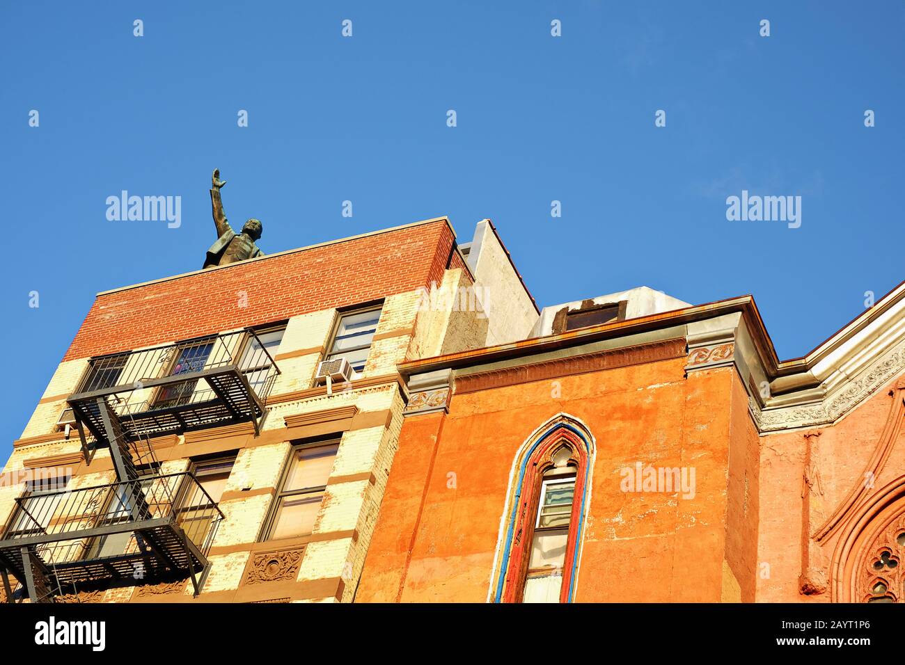 A statue of Comrade Vladimir Lenin greets American people from the rooftop of a tenement building in Greenwich Village, New York City Stock Photo