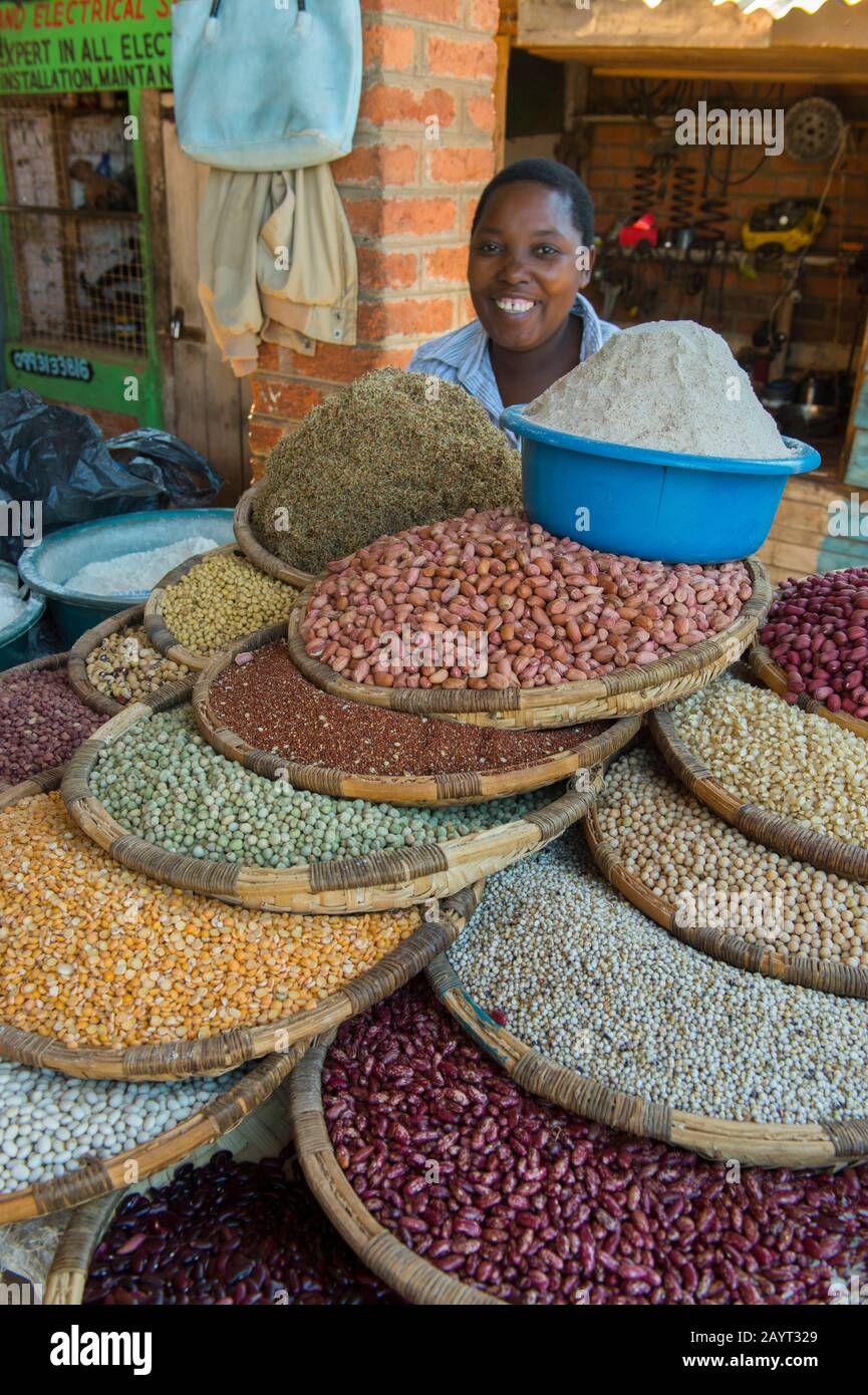 A woman selling peanuts, rice, beans and other legumes on the market in