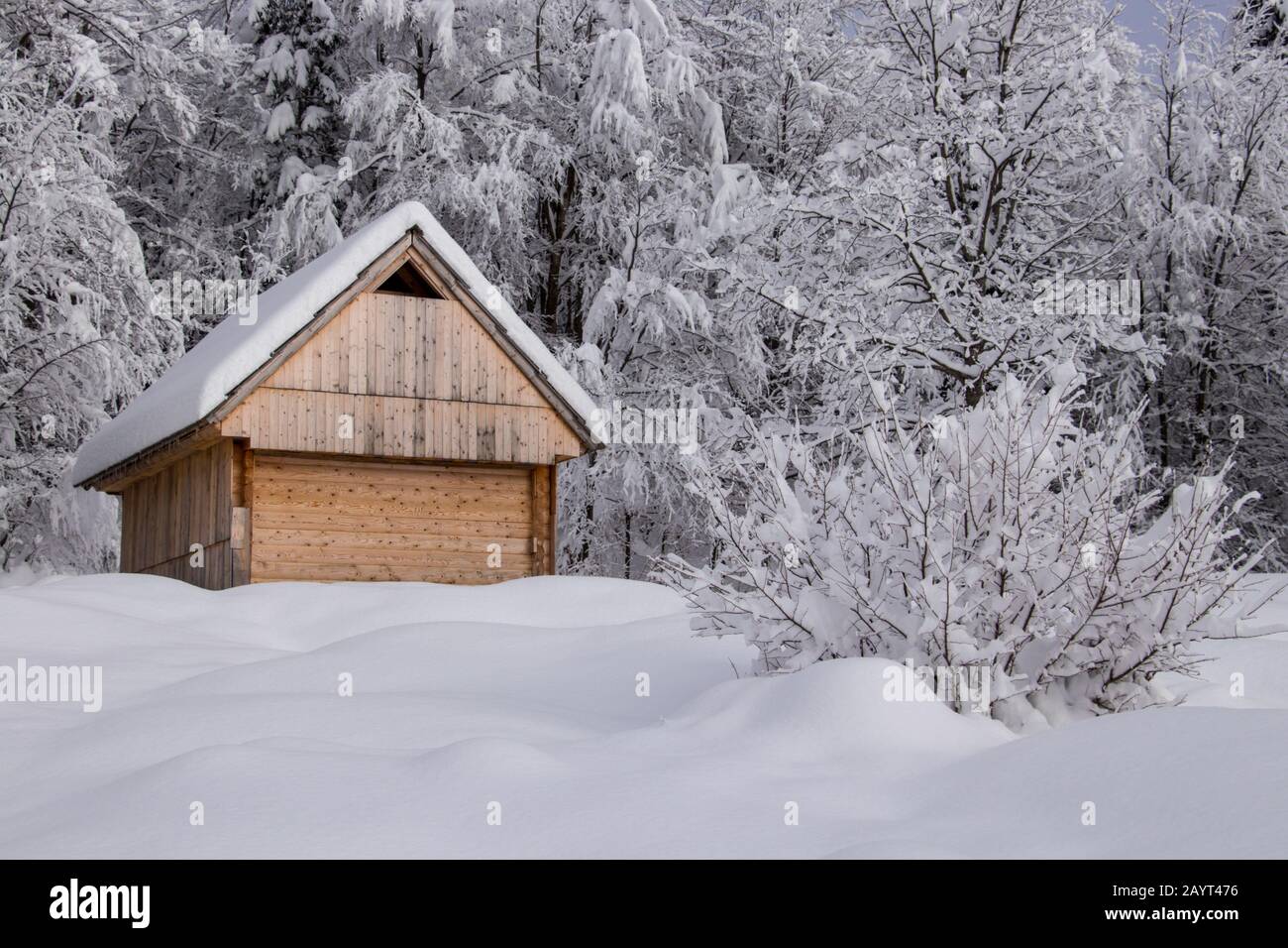 Wooden mountain cabin covered in snow Stock Photo - Alamy