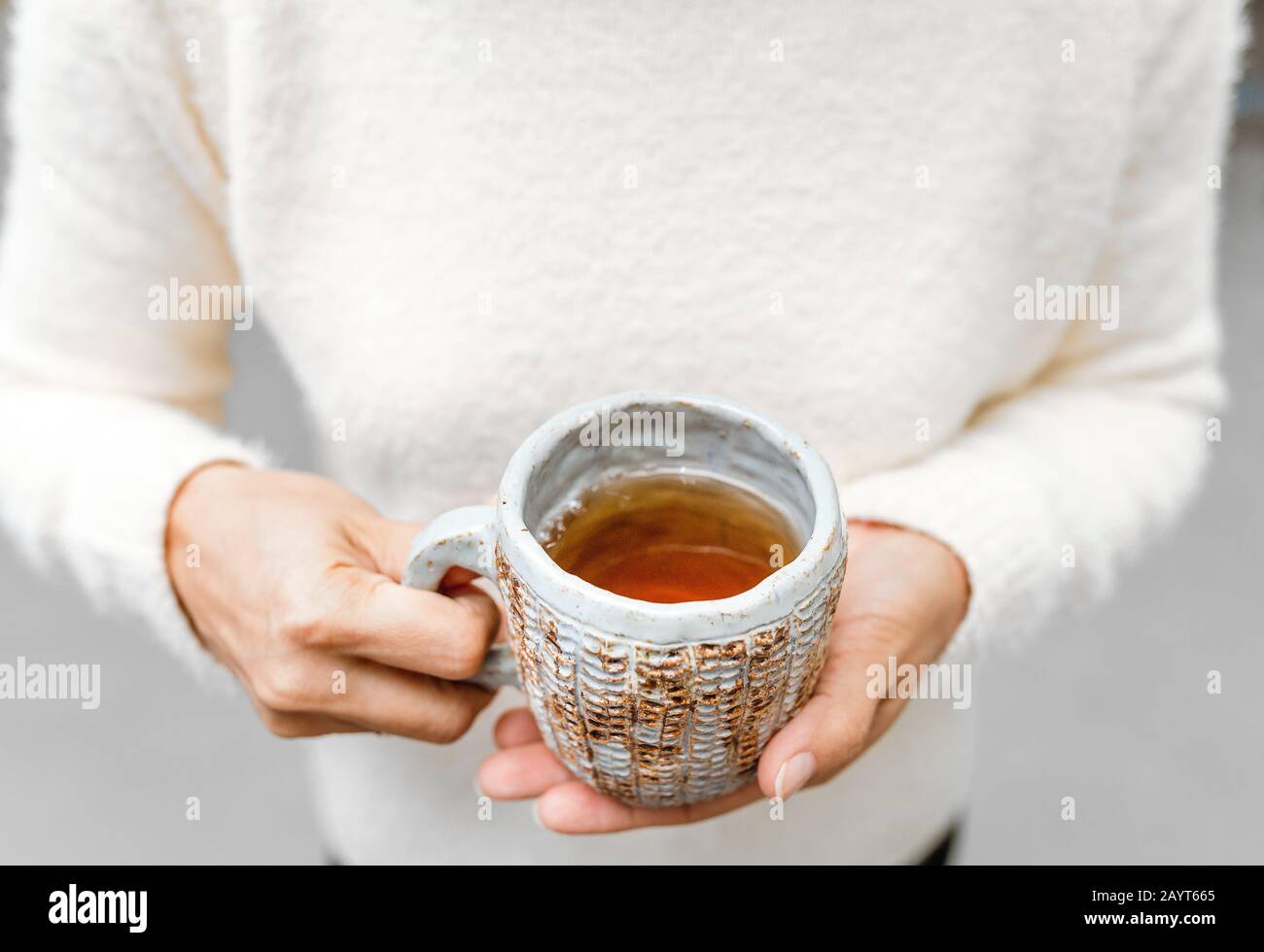 Tea cup in female hands Stock Photo