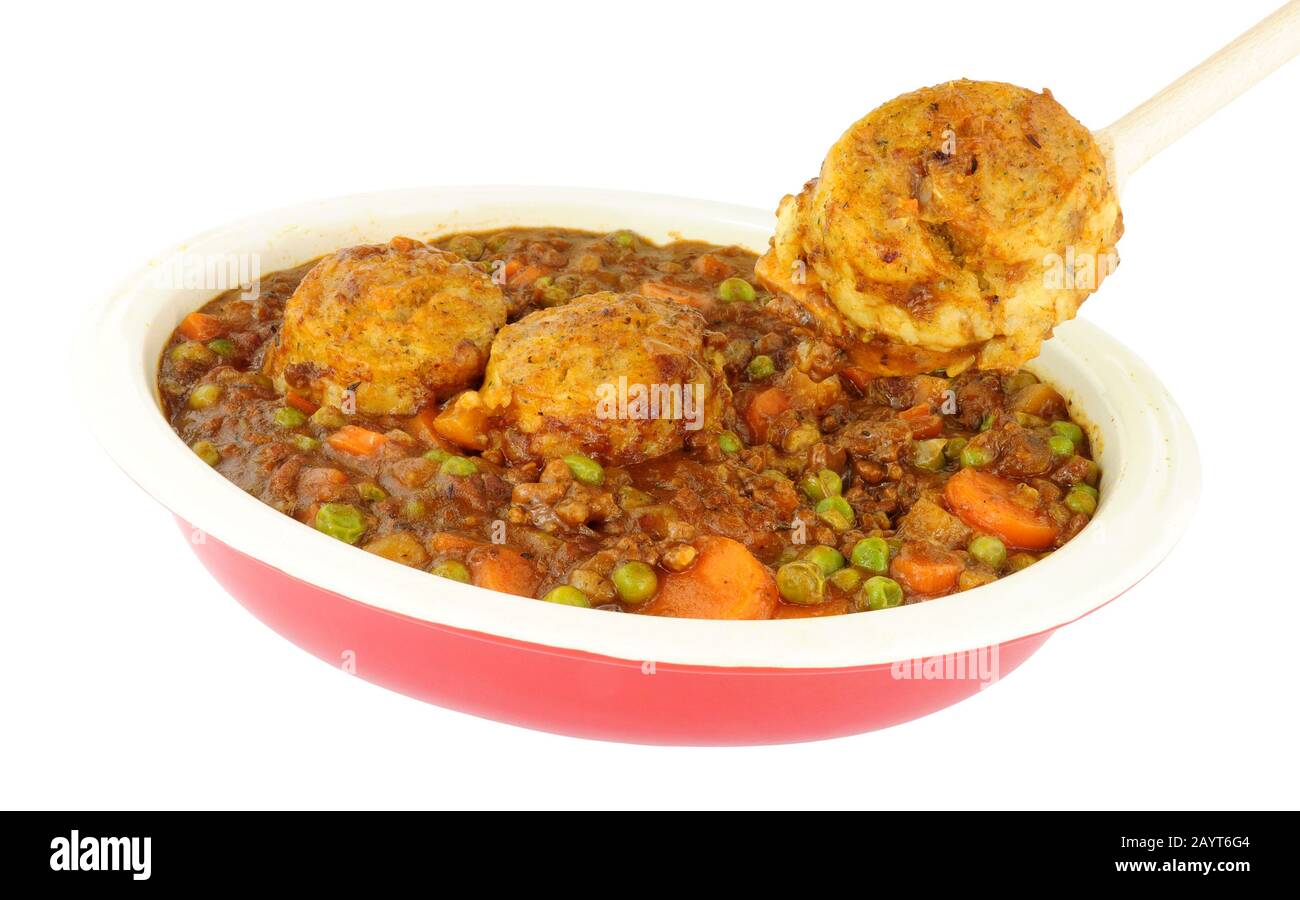 Minced beef casserole with dumplings in an oven proof dish isolated on