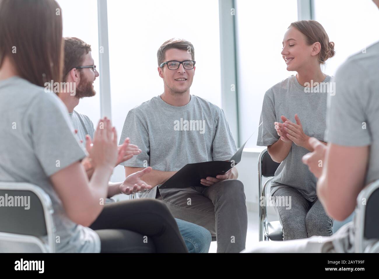 team of young people greeted the speaker with applause Stock Photo