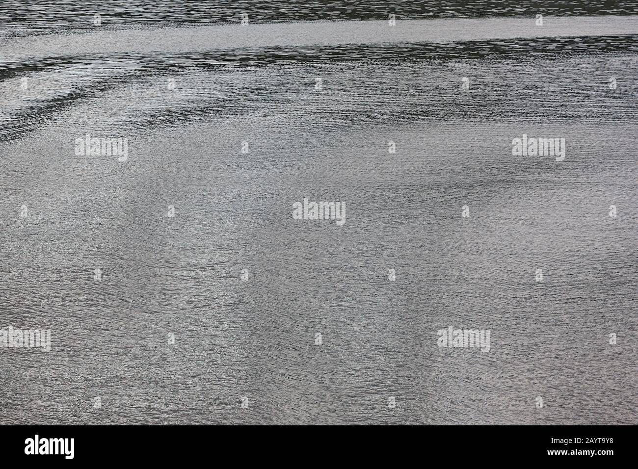 Soft waves on the sea. Water surface background. Reflection Stock Photo