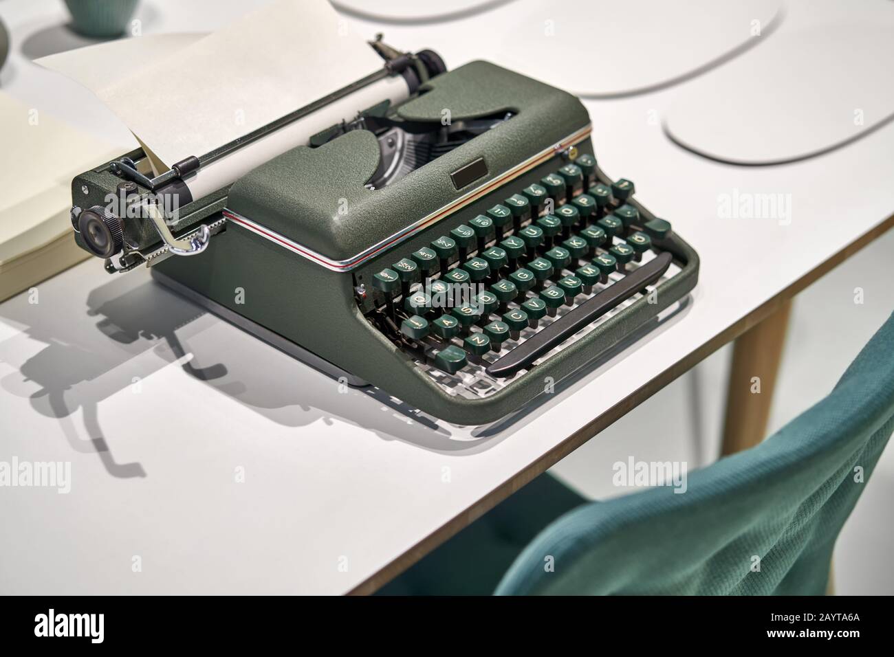Antique typewriter with sheet on light table indoors Stock Photo
