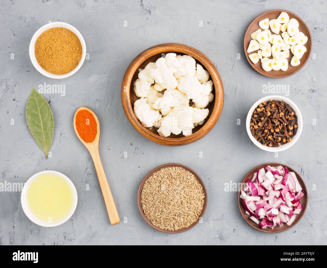 Ingredients for cooking cauliflower butter, onion, cumin (jeera), red chili pepper, masala, bay