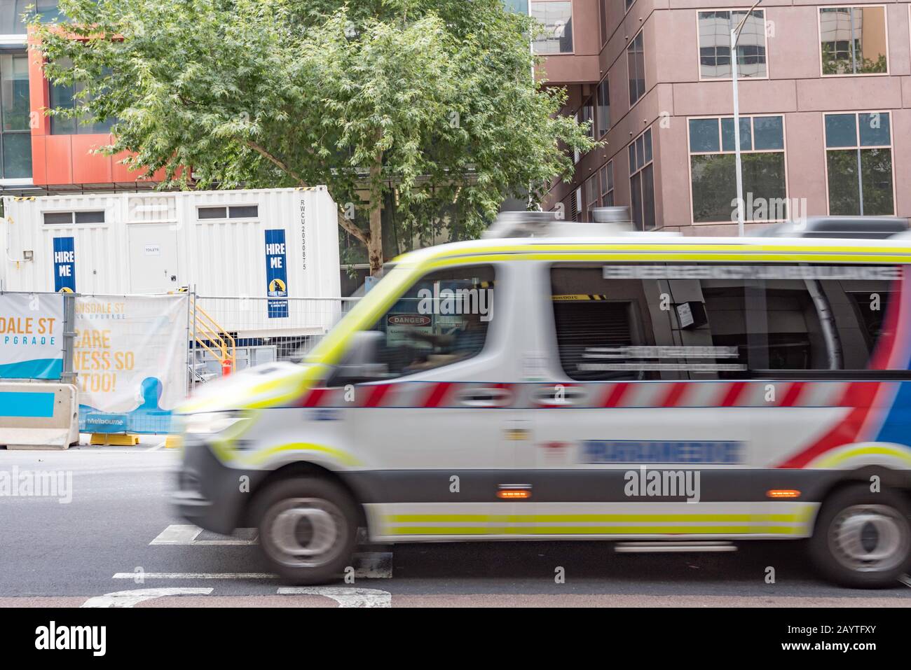 A blurred image of a Victorian paramedic ambulance rushing up Lonsdale Street in innercity Melbourne, Australia Stock Photo