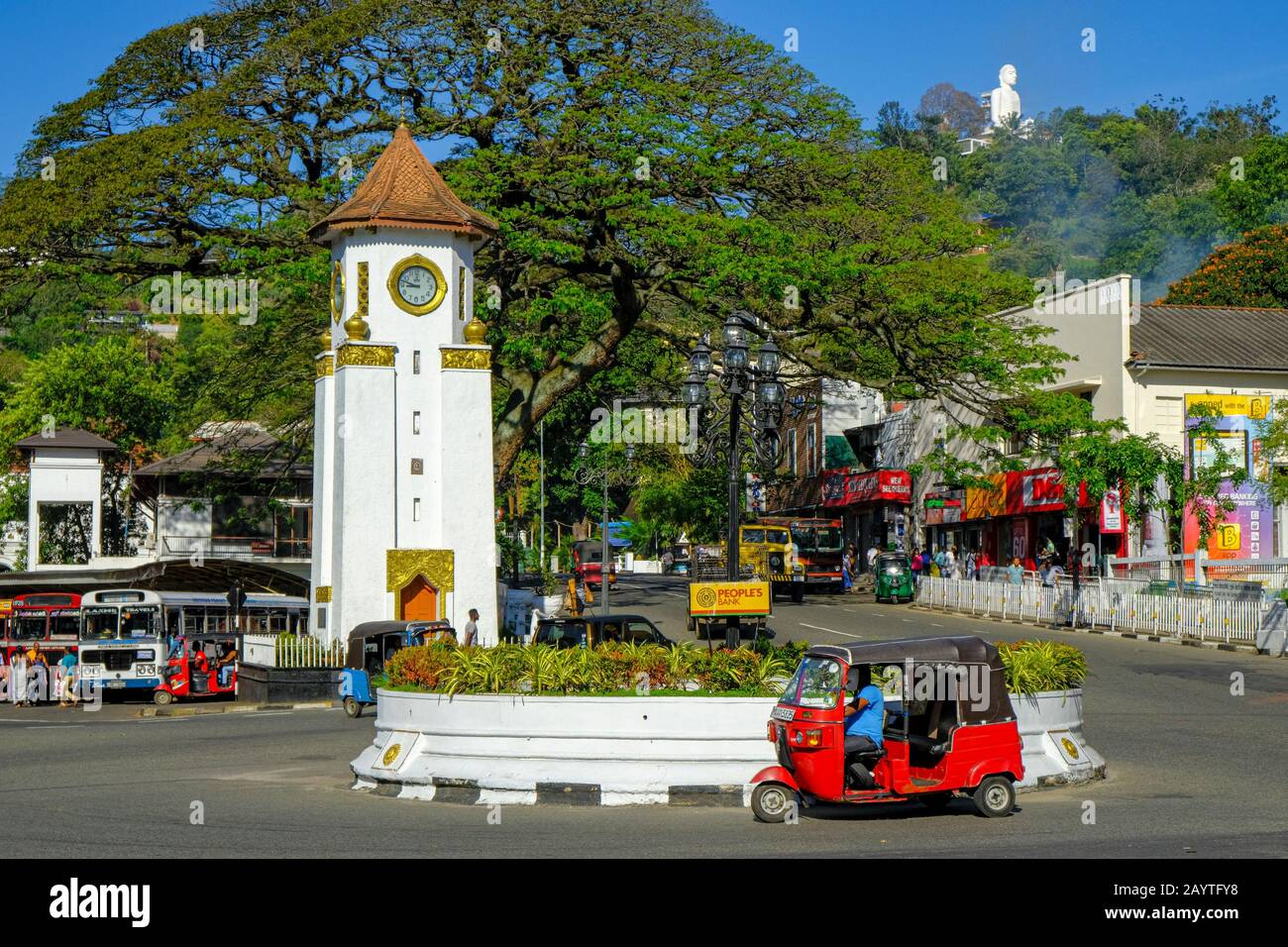 Kandy, Sri Lanka - January 2020: A tuk tuk passing in front of the clock tower on January 26, 2020 in Kandy, Sri Lanka. Stock Photo